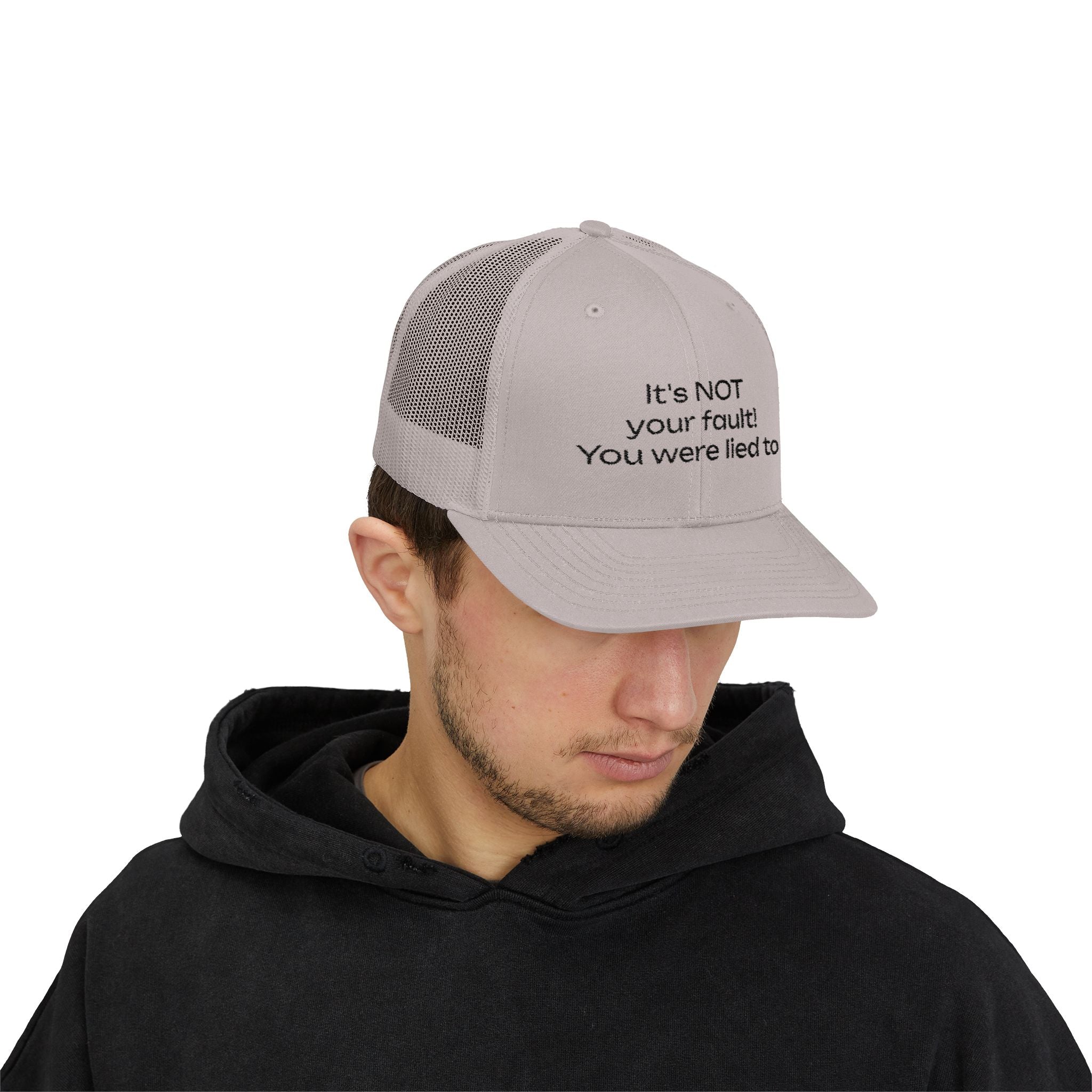 It's NOT Your Fault Trucker Cap — White Mesh Snapback with Reassuring Text
