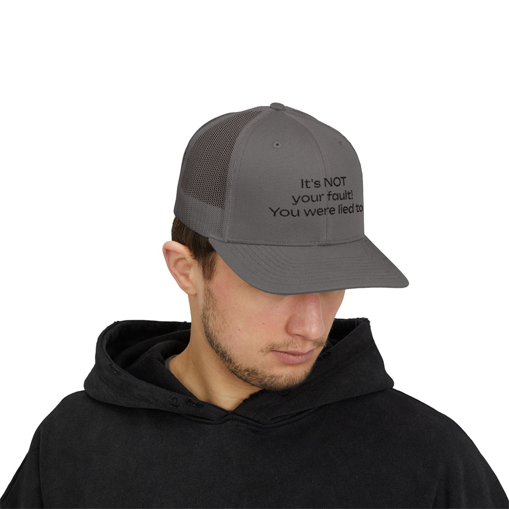 It's NOT Your Fault Trucker Cap — White Mesh Snapback with Reassuring Text