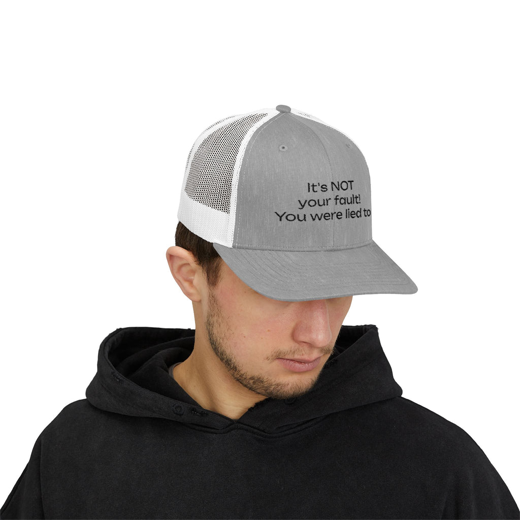 It's NOT Your Fault Trucker Cap — White Mesh Snapback with Reassuring Text