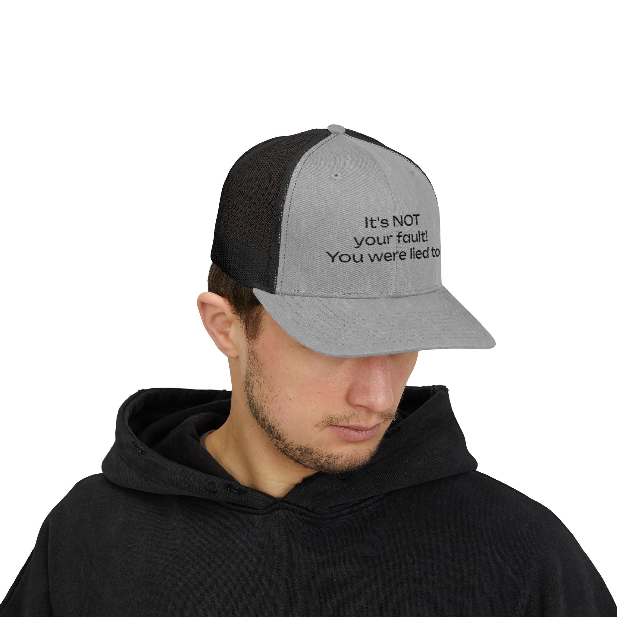 It's NOT Your Fault Trucker Cap — White Mesh Snapback with Reassuring Text