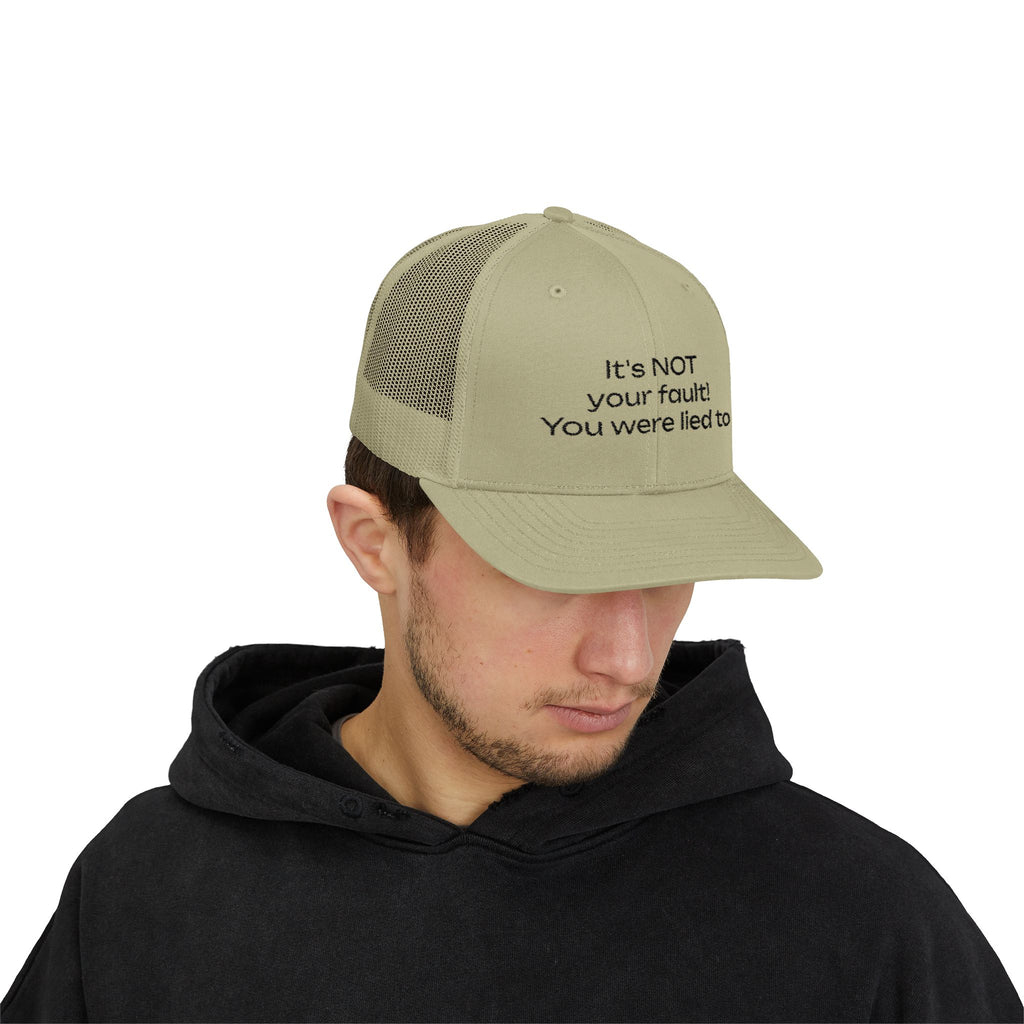 It's NOT Your Fault Trucker Cap — White Mesh Snapback with Reassuring Text