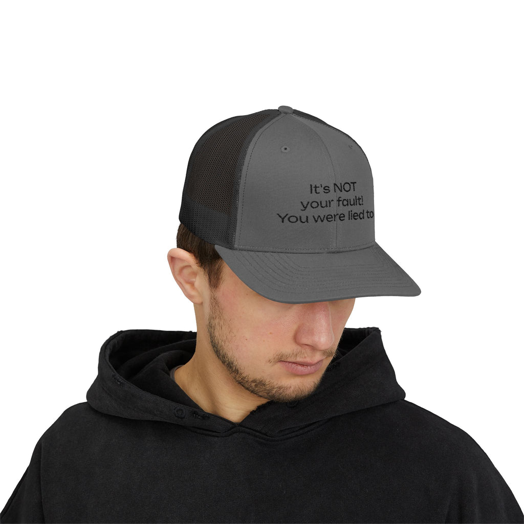 It's NOT Your Fault Trucker Cap — White Mesh Snapback with Reassuring Text